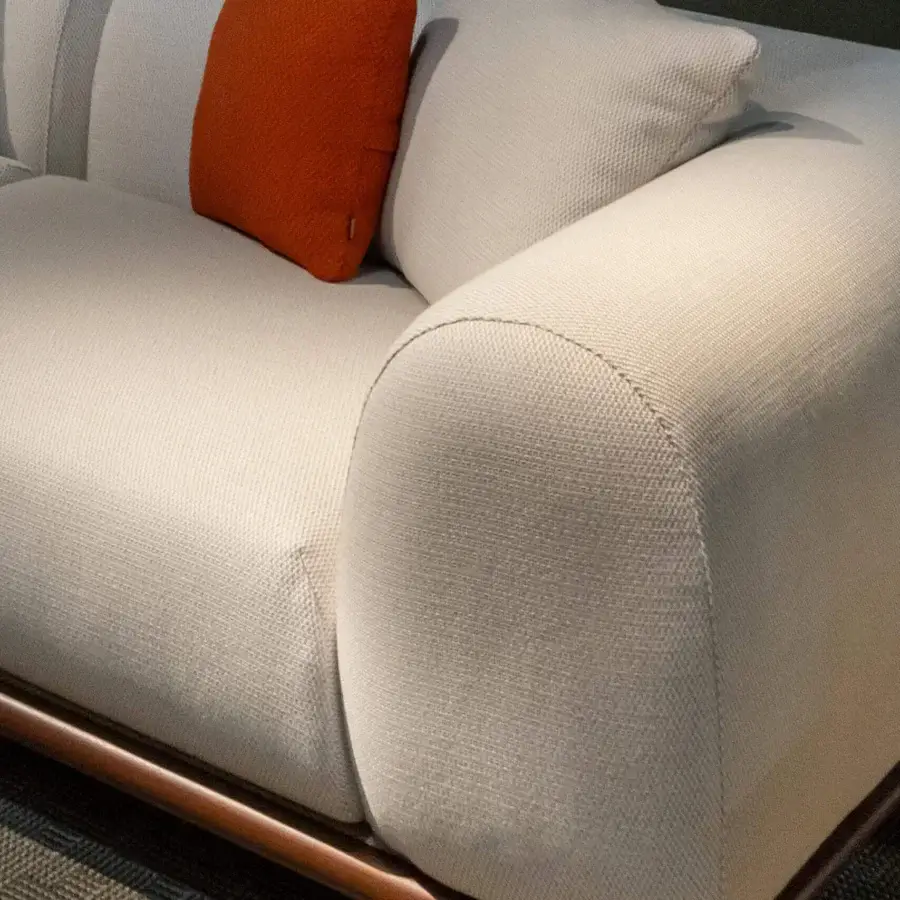 Exceptional Rugiano Amalfi sofa with warm stained mahogany, crisp chrome details, and light neutral outdoor fabric upholstery