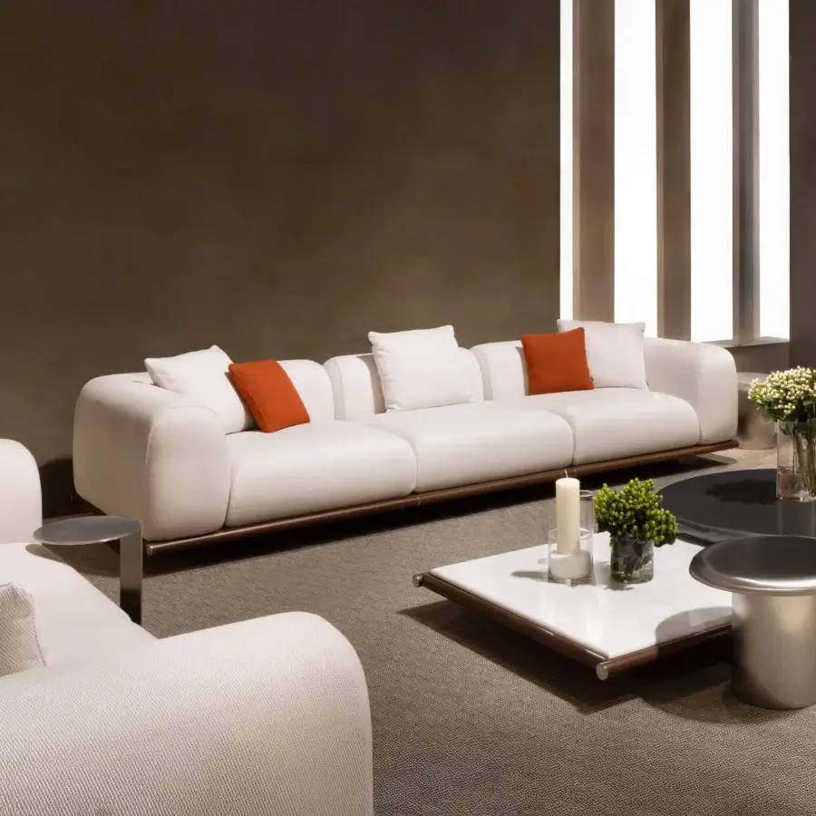 Captivating Rugiano Amalfi sofa with warm stained mahogany, chrome details, and plush off-white outdoor fabric upholstery