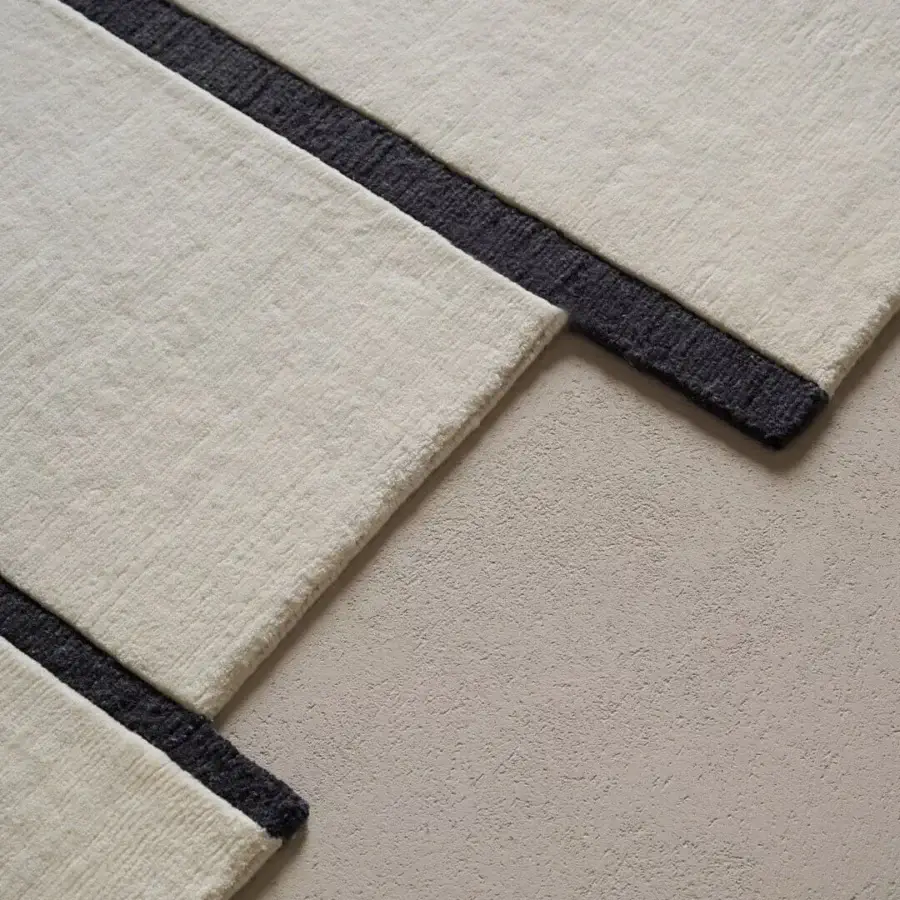 Exceptional Amini Campiture rug hand-knotted in India with off-white and dark charcoal gray New Zealand wool, exhibiting a pile loop and cut finish