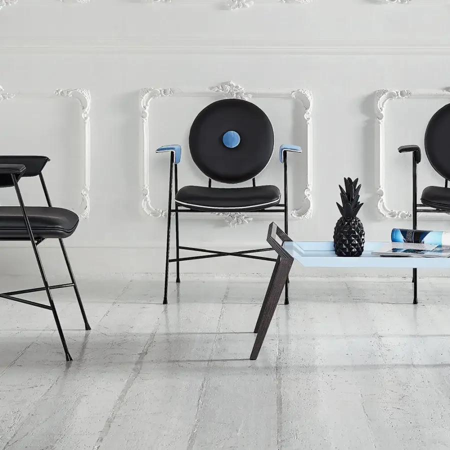 Superior Bontempi Penelope chair with curved form, matte black metal and dark textile upholstery with blue circular insert