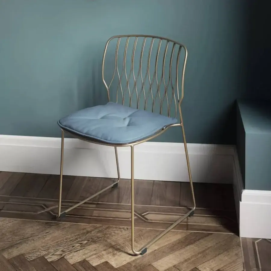 Elegant Bontempi Freak chair with gold-toned metal frame and muted blue textile cushion exhibiting balanced form