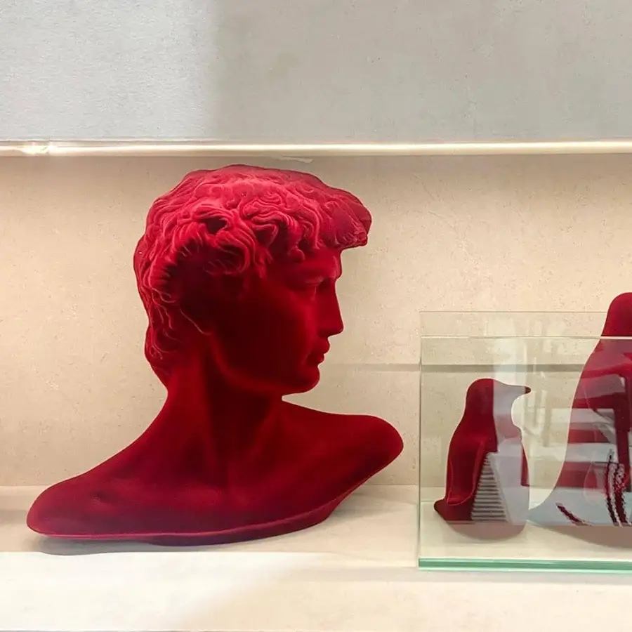 Exceptional Adriani e Rossi Little David sculpture crafted in plaster with a saturated red velvet finish