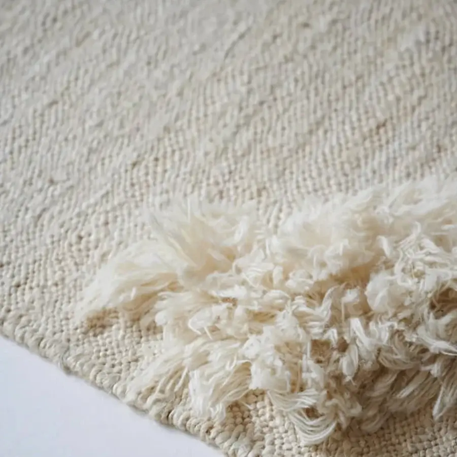 Distinguished Amini Il Volo rug with subtly textured surface hand-knotted in ivory jute and New Zealand wool with a hand-washed finish