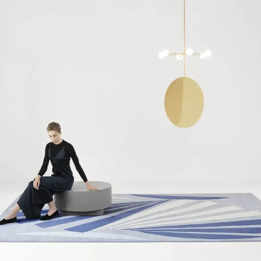 Sophisticated Amini Ventaglio rug showcases a radiating fan design in blue hues with wool and natural silk, finished with meticulous hand washing