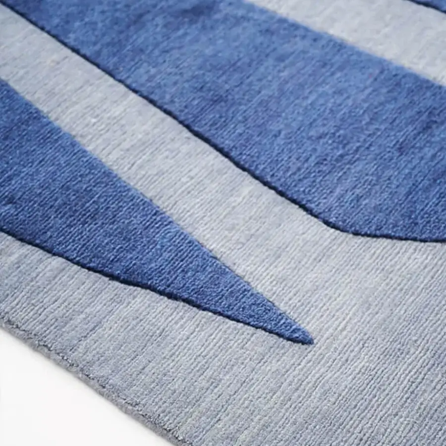 Lavish Amini Ventaglio rug displays flowing shapes in blue and gray, hand-knotted with wool and natural silk, finished with hand washing and carving