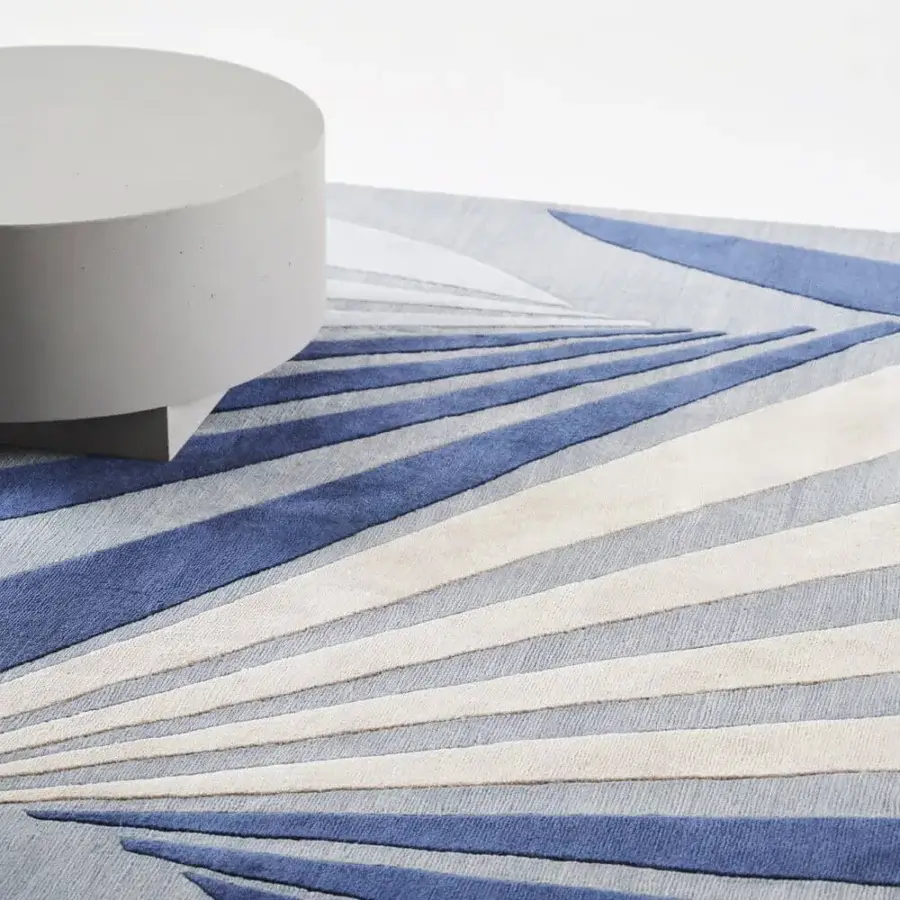 Distinguished Amini Ventaglio rug showcases dynamic geometric design with rose and blue wool and natural silk, finished with hand washing and carving