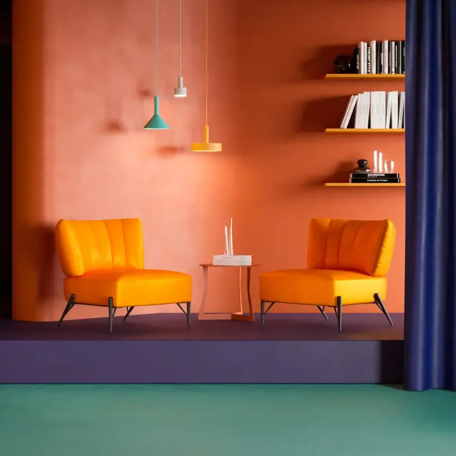 Sumptuous Egoitaliano Bluma lounge chair with soft lines in vibrant orange velvet and dark epoxy powder-coated metal legs