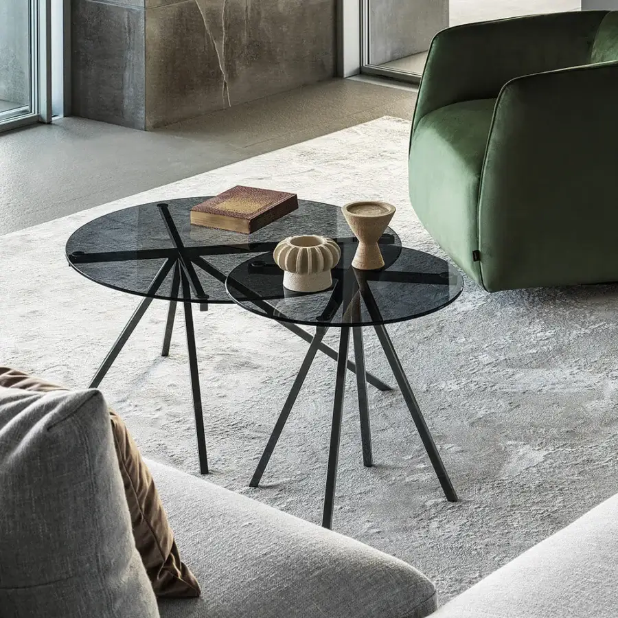 Elegant Bontempi Ray coffee table with a circular clear glass top and matte black starburst metal base
