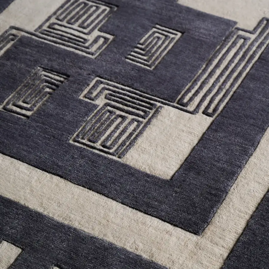 Lavish Amini Maze rug with dark blue-grey and creamy beige abstract patterns hand-knotted in Tibetan wool with meticulous carving