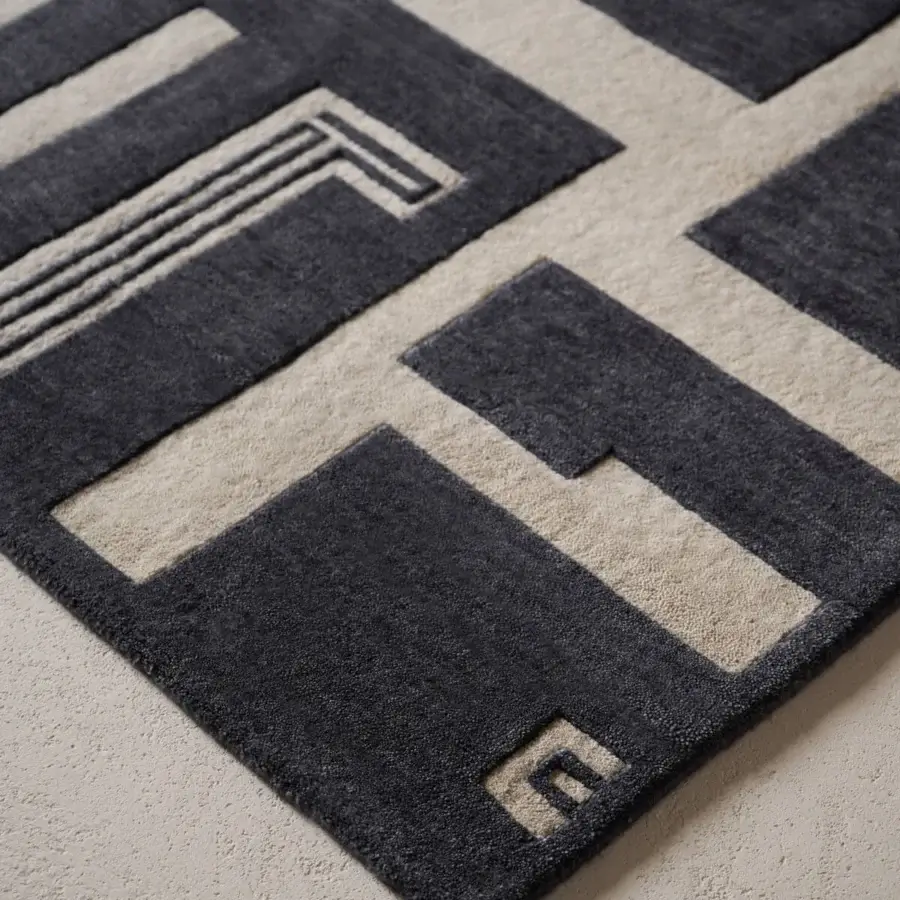 Distinguished Amini Maze rug with a contemporary black and ivory geometric pattern hand-knotted in Tibetan wool with a meticulous finish