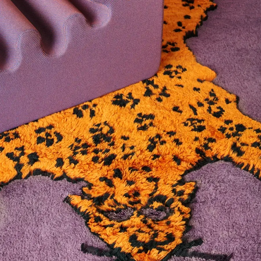 Lavish Amini Tapipardo rug with spotted animal figure in orange against a lavender pure wool finish