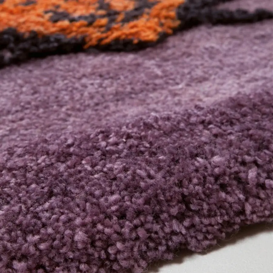 Distinguished Amini Tapipardo rug hand-knotted in pure wool showcasing blocks of orange and dark gray with a lavender backdrop and carved pile finish
