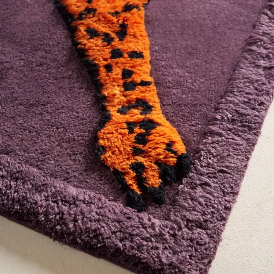 Exceptional Amini Tapipardo rug hand-knotted in pure wool with an orange paw print against a muted purple field and carved pile