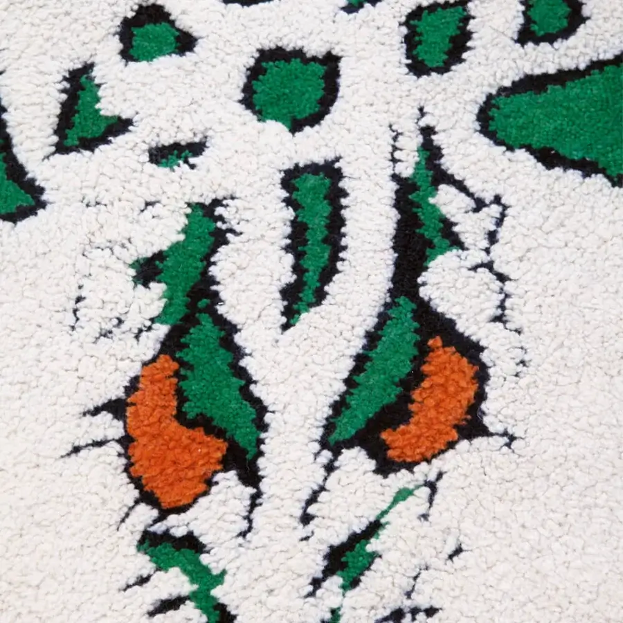 Lavish Amini Tapidrago rug hand-knotted in India with a vibrant green and white deconstructed dragon design and clipped wool finish