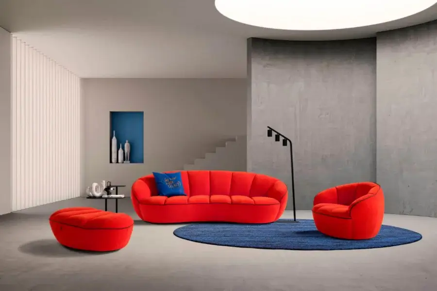 Superior Egoitaliano Shai lounge chair with rounded form upholstered in vibrant red textile and built with a wood frame