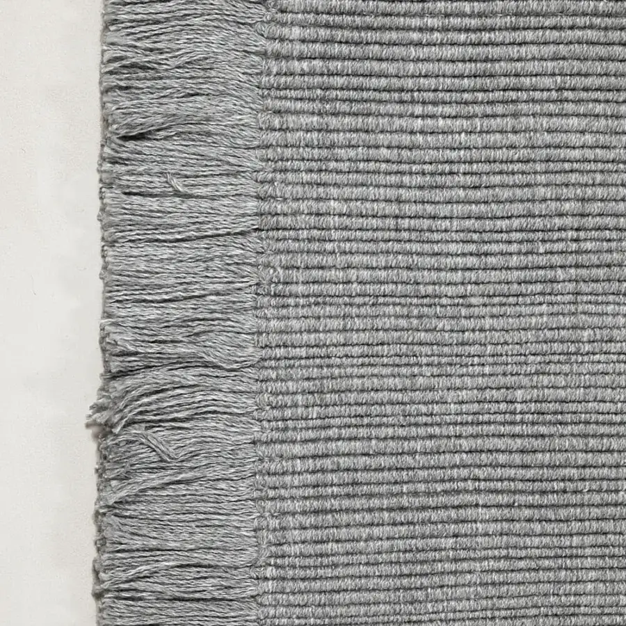 Exceptional Amini Pierre rug hand-woven in India from recycled PET with a textured matte surface and loosely knotted fringe
