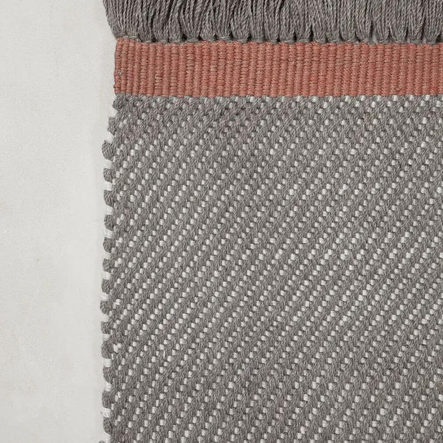 Elegant Amini Sesame rug with contemporary herringbone and hand-clipped detailing crafted in recycled PET with taupe and coral hues