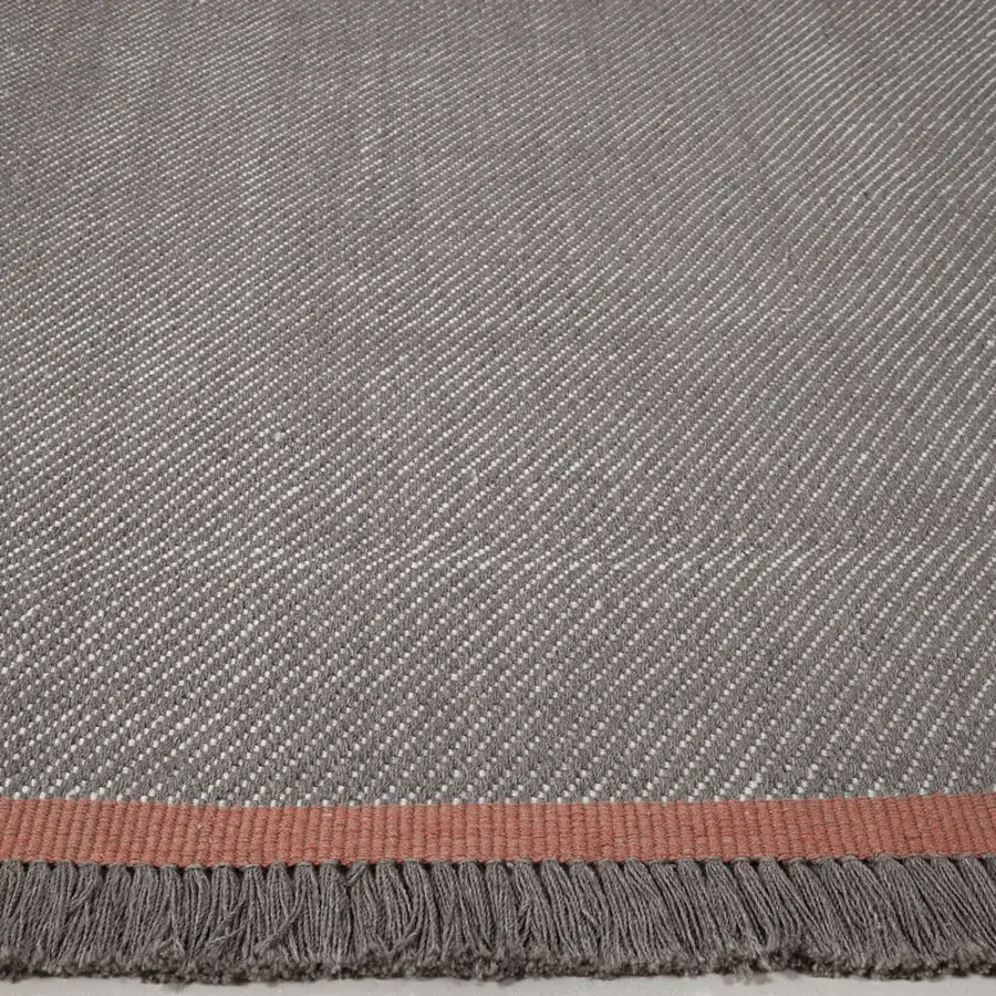 Distinguished Amini Sesame rug with heathered grey tones, a subtle coral accent band and hand-clipped recycled PET detailing