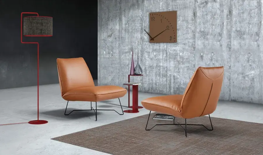 Distinguished Egoitaliano Lia lounge chair with warm brown textured leather upholstery and sleek steel epoxy powder finish