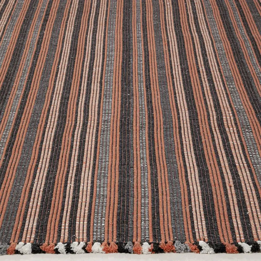 Sophisticated Amini Prune rug hand-woven from recycled PET in charcoal and coral with textured finish