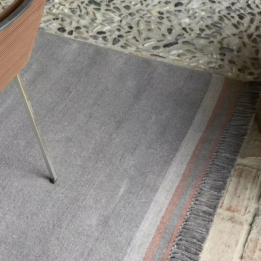 Exceptional Amini Coco rug with heathered grey and coral stripes crafted in recycled PET with a hand-clipped finish