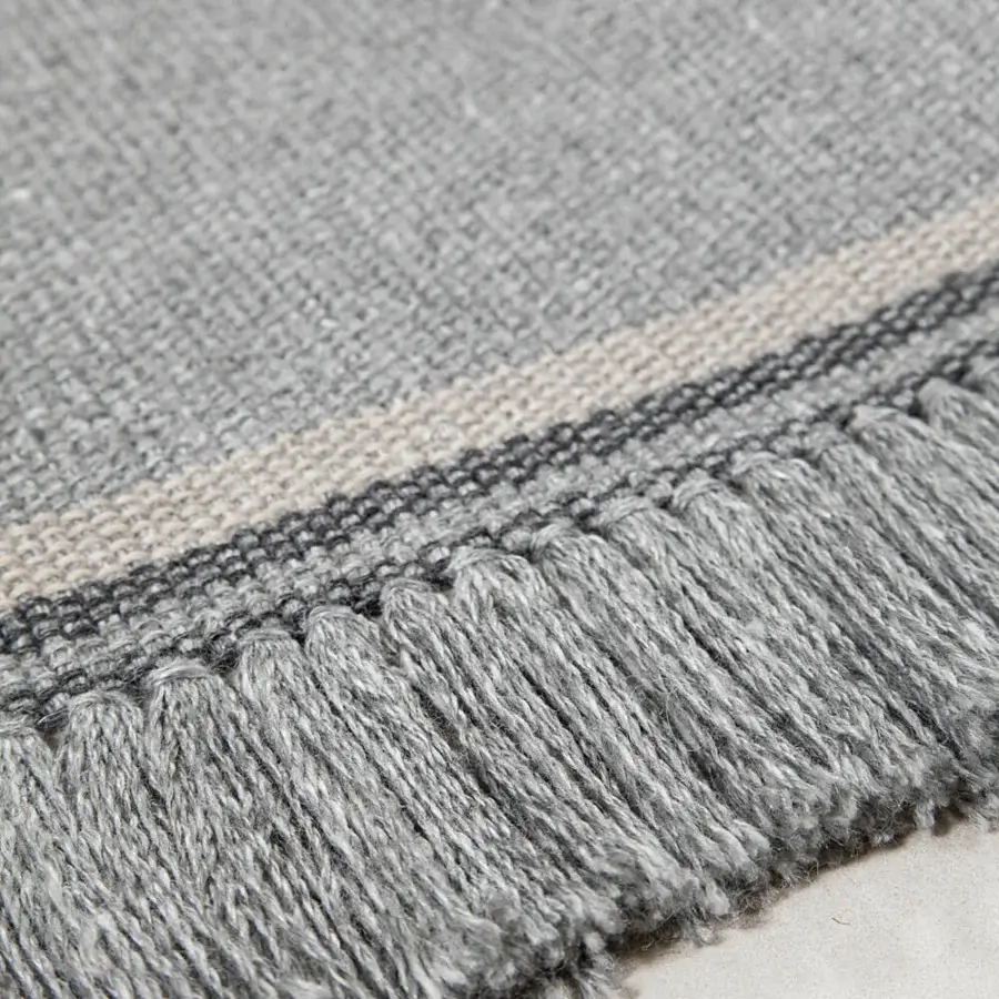 Distinguished Amini Coco rug crafted from recycled PET with a decorative edge and muted grey beige stripe