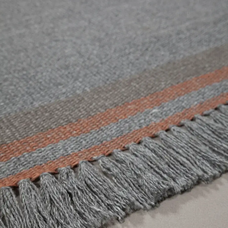 Exceptional Amini Coco rug hand-woven from recycled PET with muted orange-brown stripes and a fringed edge