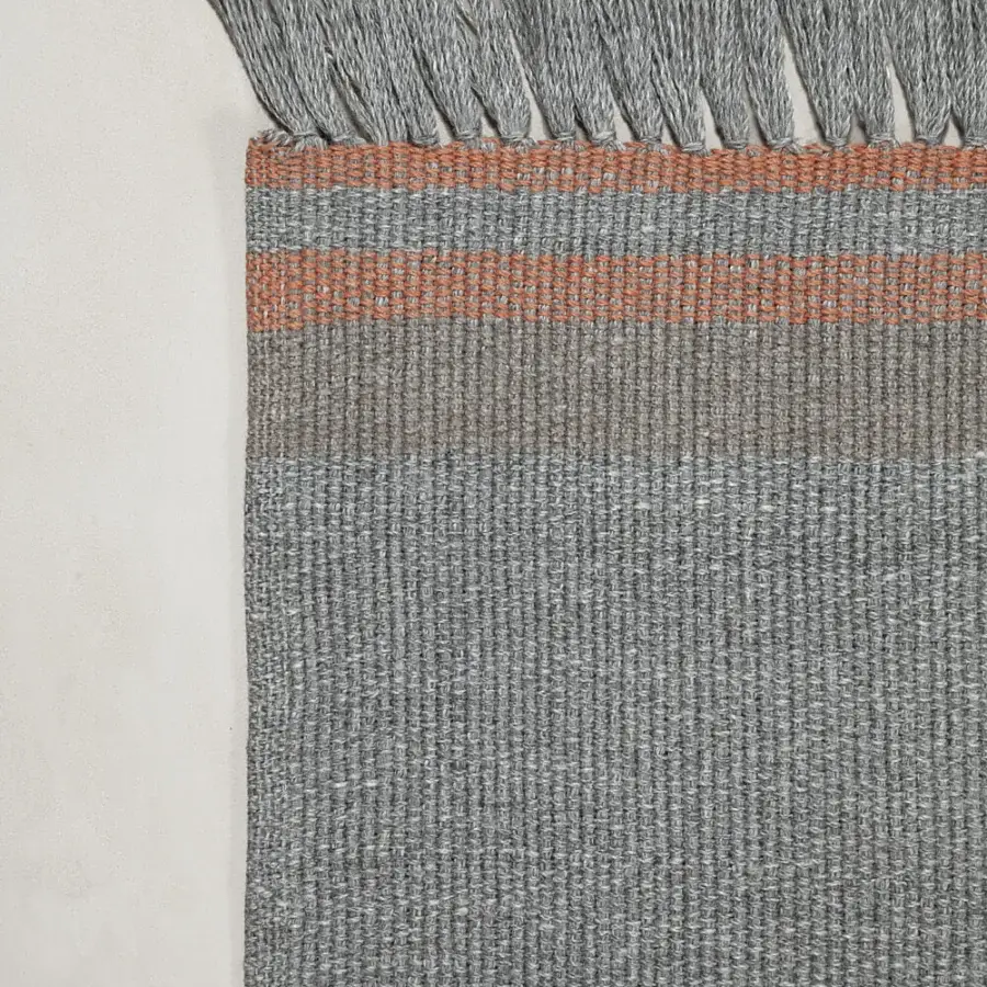 Elegant Amini Coco rug crafted from recycled PET in muted grey and coral with a hand-clipped finish
