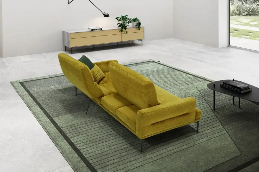Elegant Egoitaliano Feng sofa with vibrant mustard yellow velvet textile upholstery and dark epoxy powder-coated metal legs