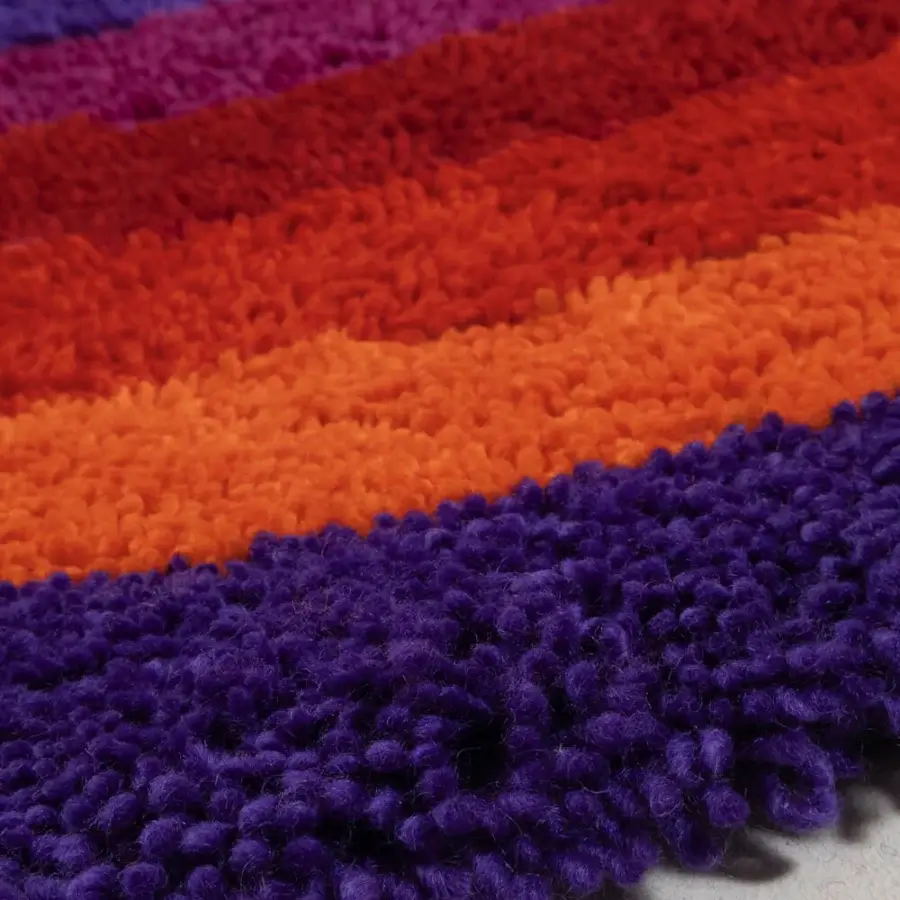Distinguished Amini Romantica-Curve rug hand-tufted in chromatic stripes of purple, orange, and blue New Zealand wool with a clipped finish
