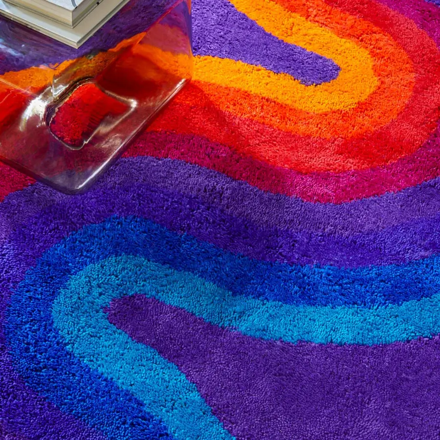 Exquisite Amini Romantica-Curve rug hand-tufted with vibrant waves of red, purple, and blue New Zealand wool with a clipped finish