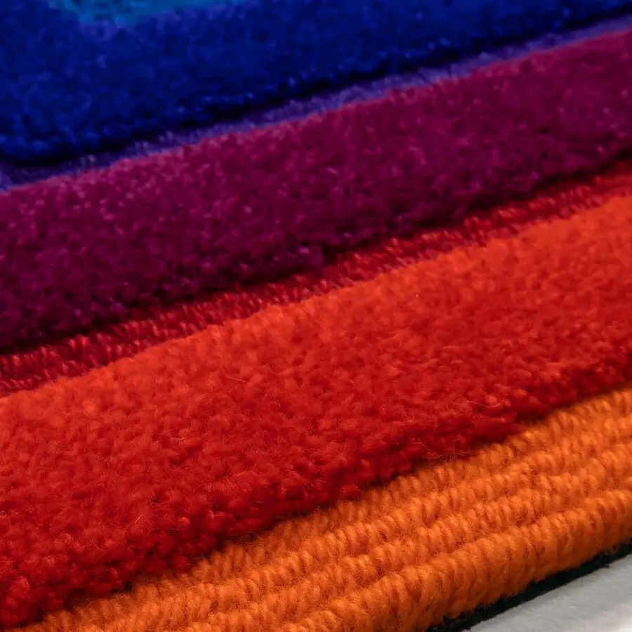 Exceptional Amini Domino rug hand-tufted in New Zealand wool with vibrant horizontal stripes and carved texture
