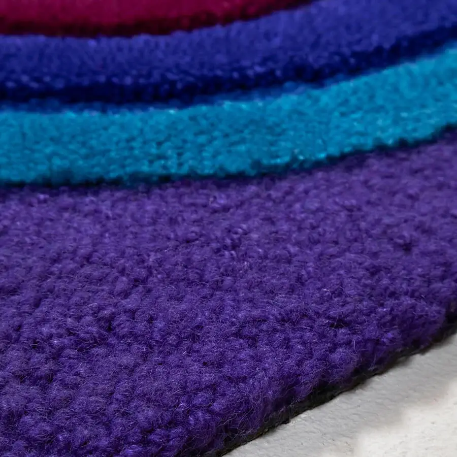 Lavish Amini Domino rug crafted from New Zealand wool with vibrant purple and blue concentric layers and hand-tufted pile