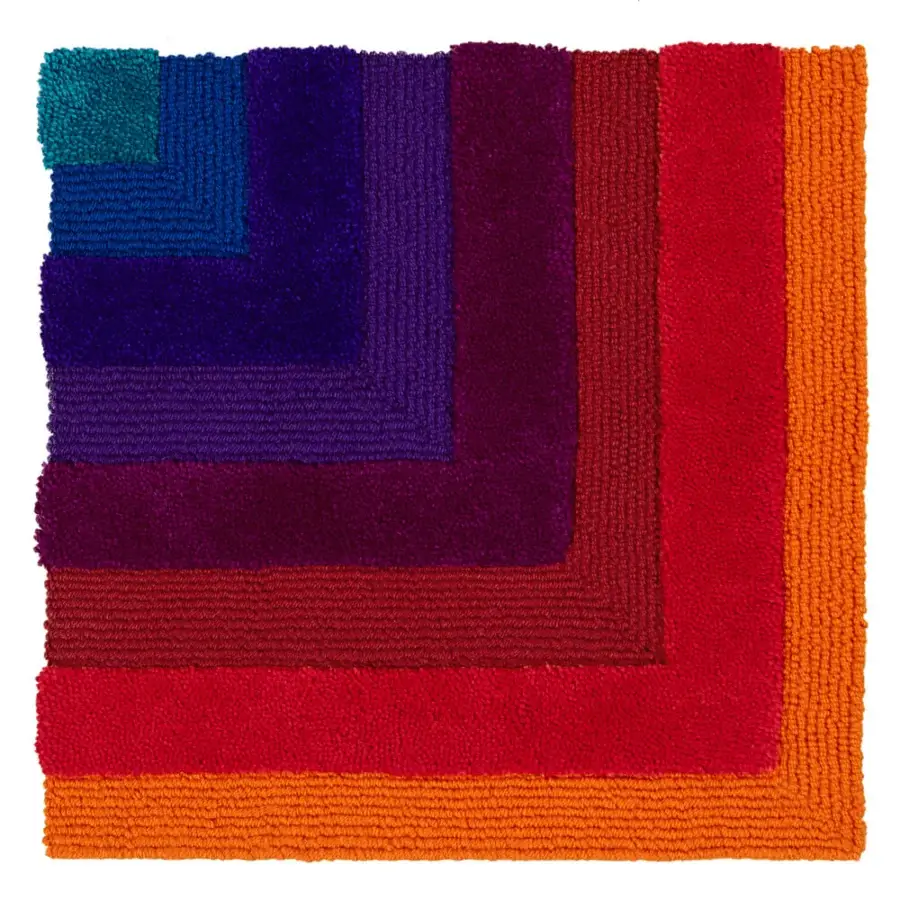 Distinguished Amini Domino rug showcasing a gradient of teal-blue, violet, and red hand-tufted in New Zealand wool with a carved finish