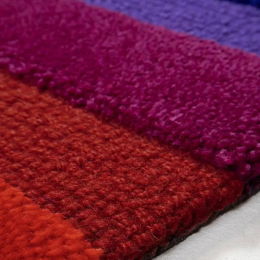 Exceptional Amini Domino rug crafted with vibrant red, magenta, and violet-blue wool modules with a hand-washed pile