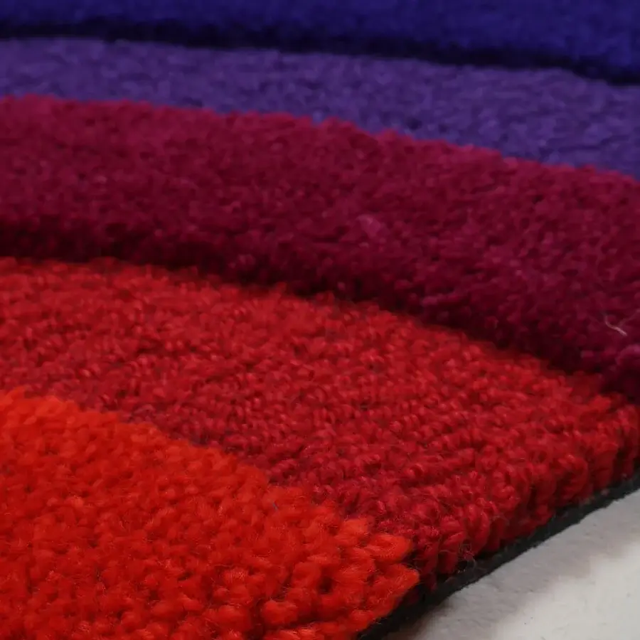 Lavish Amini Domino rug crafted with a wave pattern in orange, red, and teal New Zealand wool with hand-tufted pile