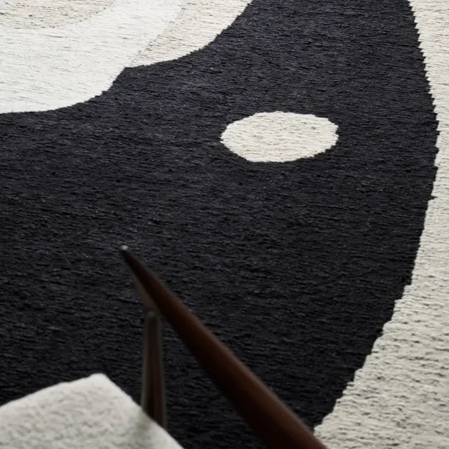 Distinguished Amini Jean rug with a captivating organic form in ivory and dark grey wool, hand-clipped using the Soumak technique