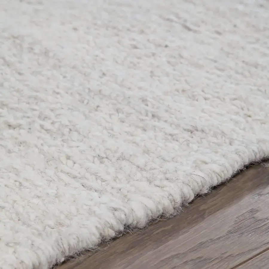 Superior Amini Jean rug woven from soft wool with delicate abstract shapes in ivory, dark grey, and brown hues, hand-clipped finish