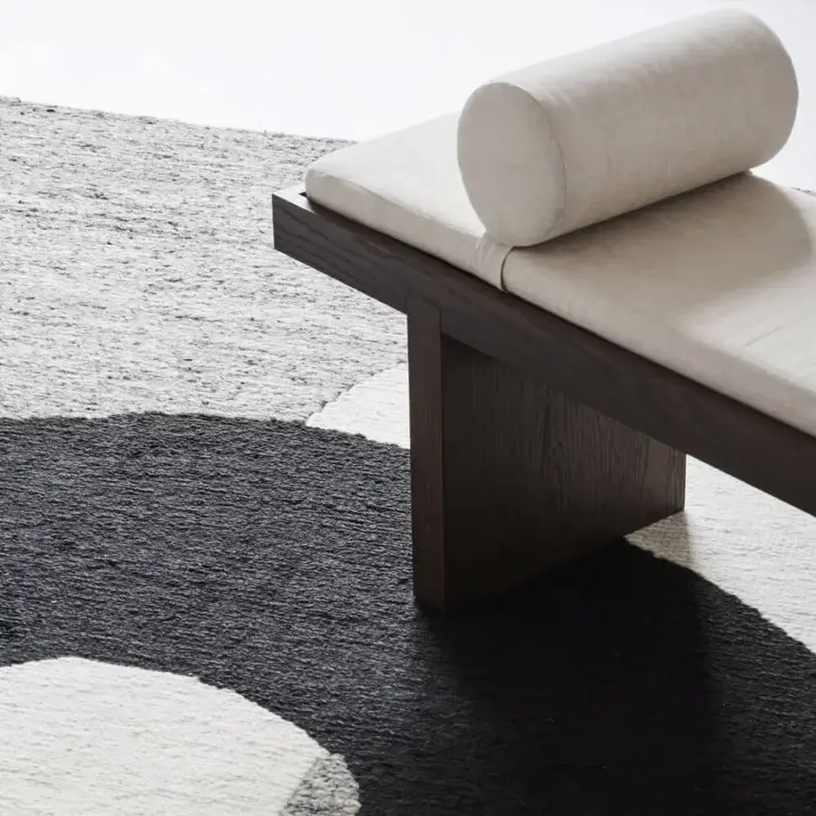 Superior Amini Jean rug displaying an abstract black and off-white design hand-clipped and woven with a soft wool pile