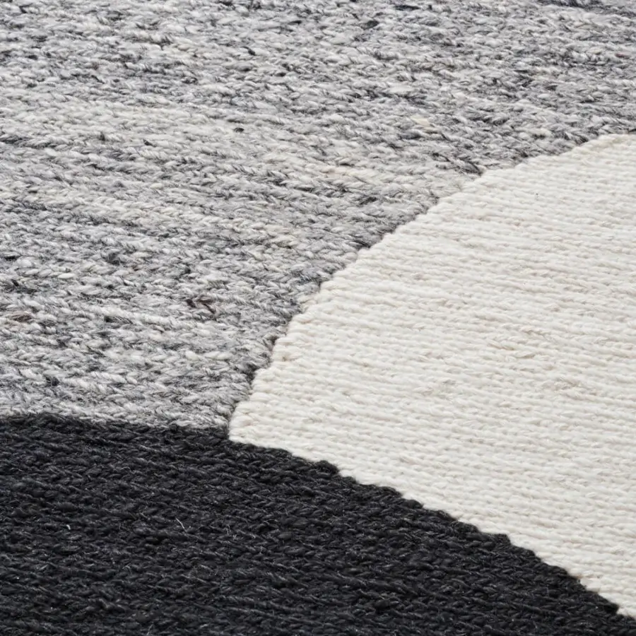 Exceptional Amini Jean rug displaying organic shapes hand-clipped and woven with ivory, dark grey, and brown wool pile