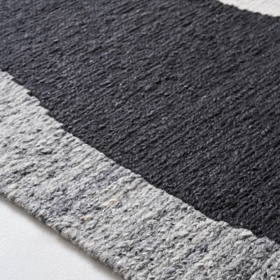 Distinguished Amini Jean rug displaying a contemporary geometric design hand-clipped and woven in black and white wool