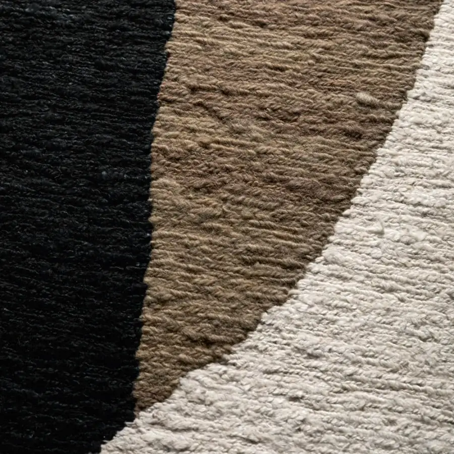Lavish Amini Jean rug hand-clipped and woven with luxurious wool displaying dark grey, ivory, and brown hues inspired by natural elements