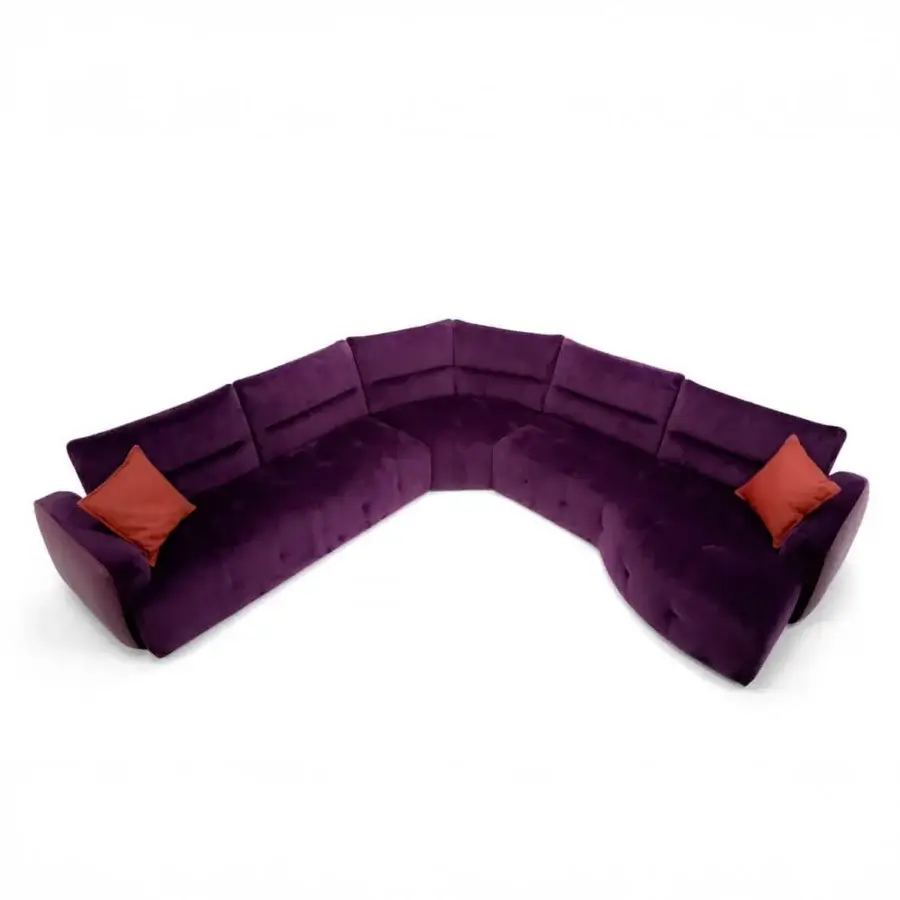 Sumptuous Egoitaliano Mavie sectional with deep purple matte velvet upholstery and vibrant orange cushions built with detailed piping