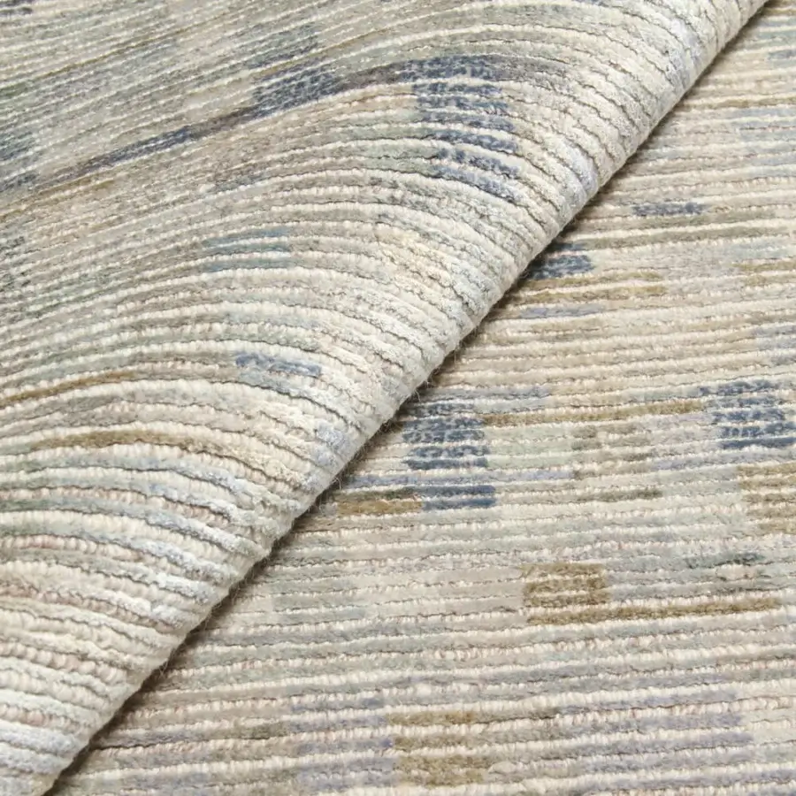 Lavish Amini Lake rug hand-knotted in Nepal with a gradient of muted blue, beige, and gray pure silk exhibiting meticulous carving