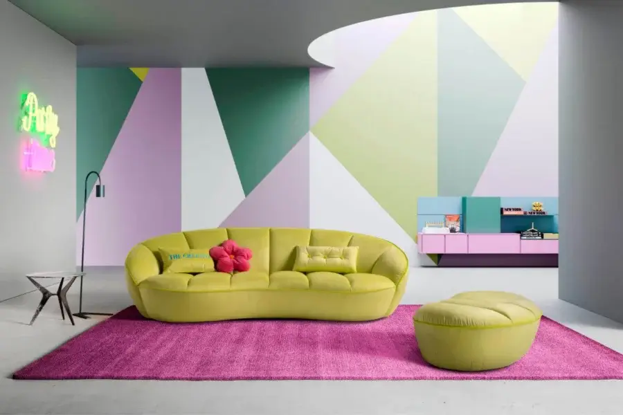Exclusive Egoitaliano Shai sofa with a low curved silhouette upholstered in muted chartreuse bi-elastic fabric and vertical stitching