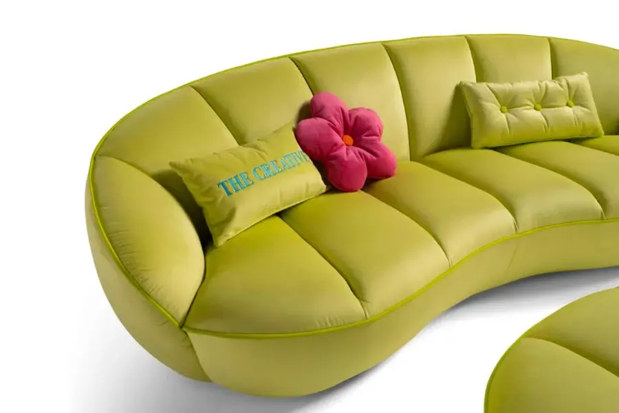Superior Egoitaliano Shai sofa with a distinctive curved form upholstered in light green bi-elastic fabric and delicate beige piping