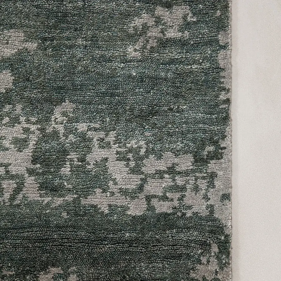 Distinguished Amini Pangea Geo rug hand-knotted in wool and bamboo silk with a mottled green-gray surface and hand-washed finish