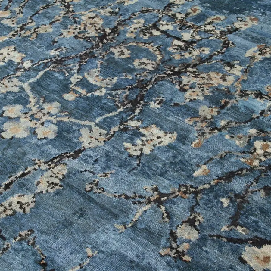 Lavish Amini Vincent rug crafted from pure silk with muted blue and delicate cream floral motifs, finished with hand washing and carving