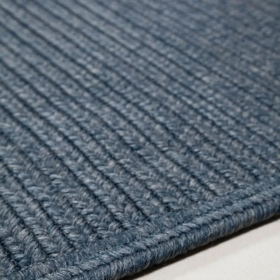 Lavish Amini Plain rug hand-braided in India with polypropylene, viscose, and polyester in a muted blue hue with hand clipping