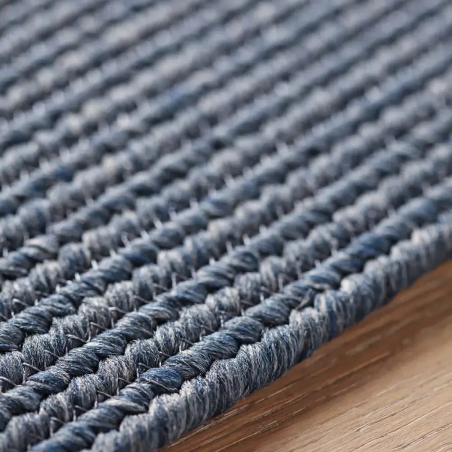 Distinguished Amini Plain rug hand-braided in a nuanced shade of blue with polypropylene, viscose, and polyester, finished with hand clipping